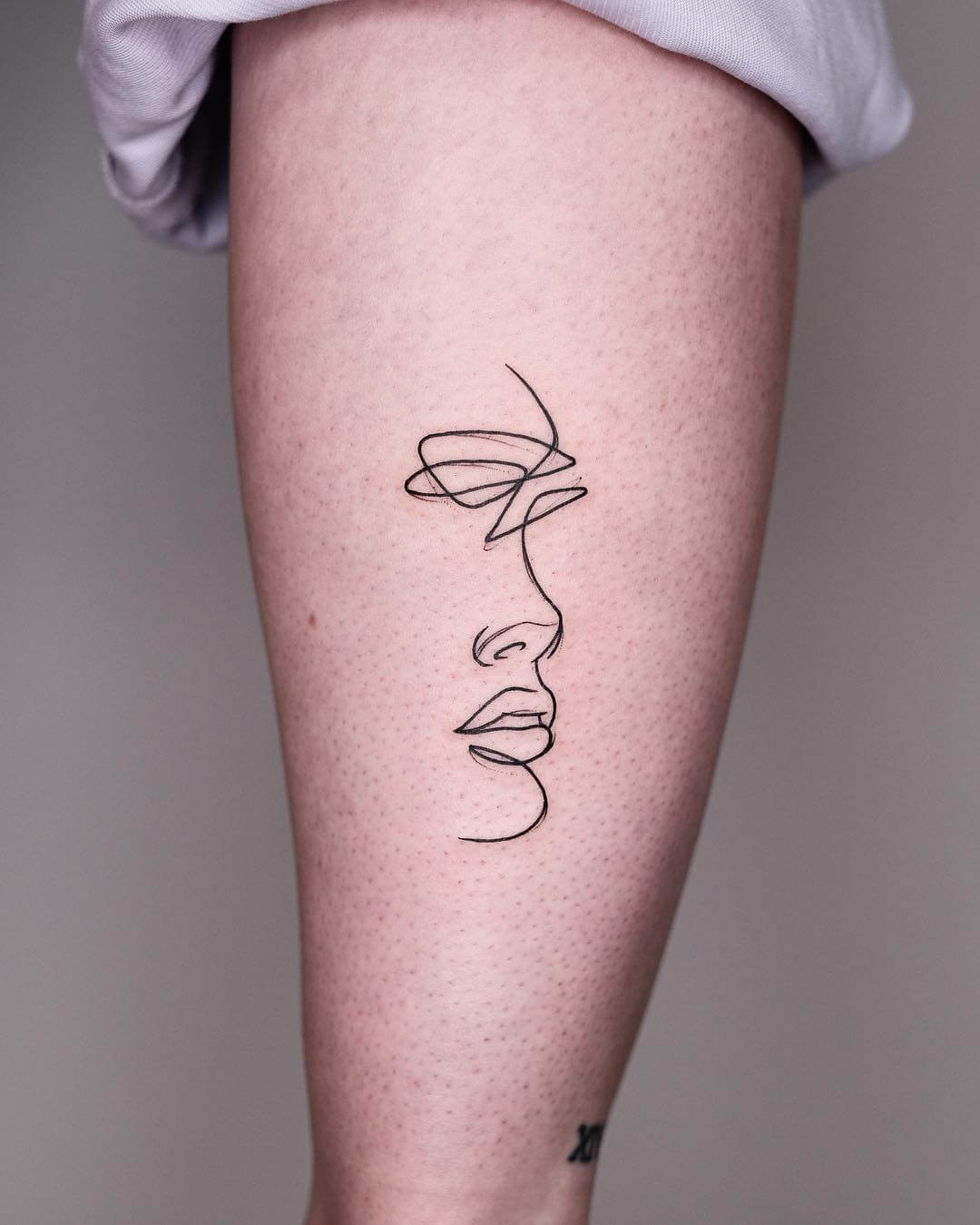 Marc Bonin minimalsm face tattoo